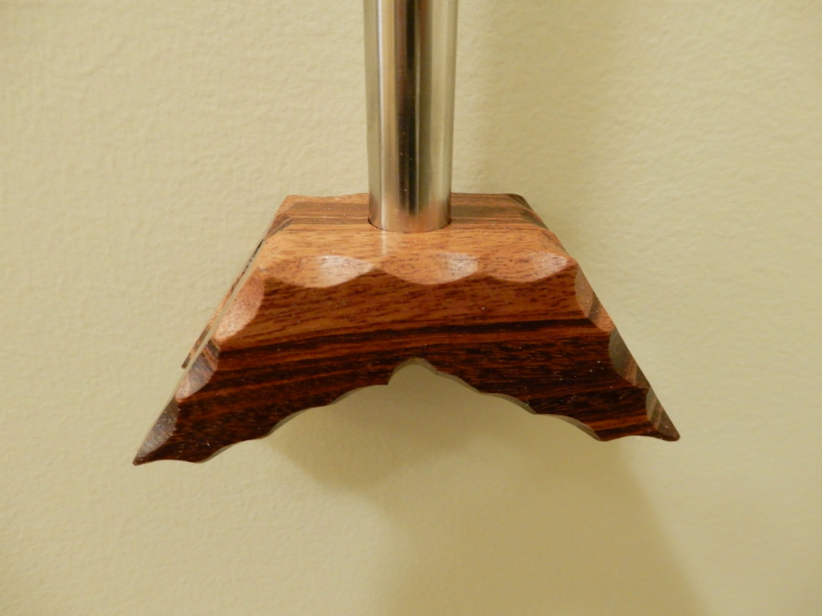 A carved cocobolo 'handle' at the end of a SS [stainless steel] pipe.